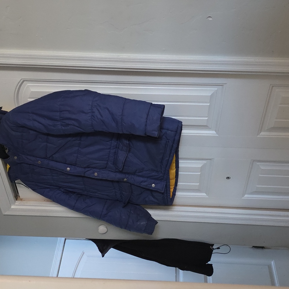 Blue Hooded Puffer Jacket with Yellow Lining. This Jacket Is In Great Cond.